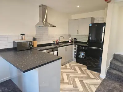 a kitchen with a black and white counter top at Carlisle City Centre. The Foremans Residence. in Carlisle