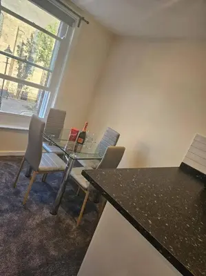 a room with a table and chairs and a window at Carlisle City Centre. The Foremans Residence. in Carlisle