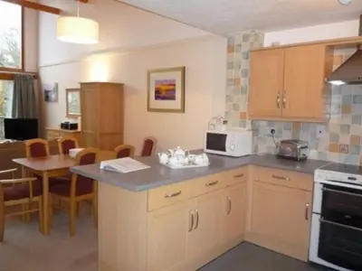 a kitchen with a counter and a table with a microwave at Keswick Bridge 21, within walking distance of Keswick town centre, strictly no pets in Keswick