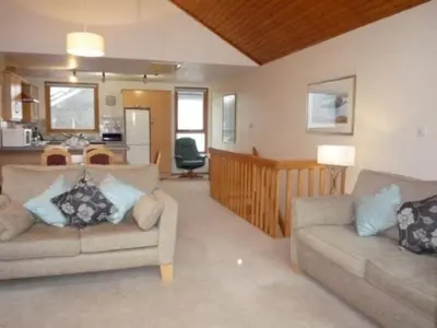 a living room with two couches and a kitchen at Keswick Bridge 21, within walking distance of Keswick town centre, strictly no pets in Keswick