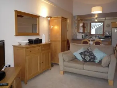 a living room with a couch and a kitchen at Keswick Bridge 17, within walking distance of Keswick town centre, strictly no pets in Keswick