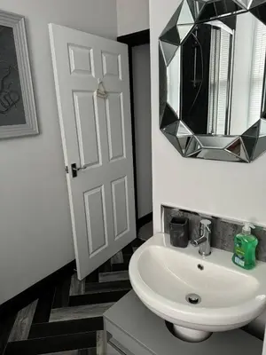 a bathroom with a white sink and a mirror at Lowther Apartment - 2 Bedrooms - Sleeps 4 in Whitehaven