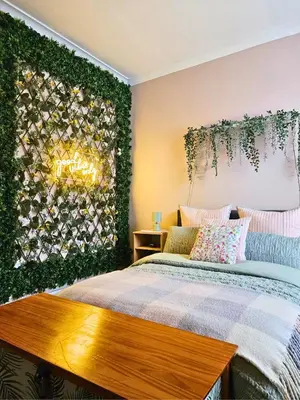 a bedroom with a bed and a green wall at The Ferns - Modern Apartment With Parking & Shared Garden in Darvel
