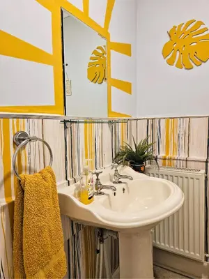 a bathroom with a sink and a mirror at The Ferns - Modern Apartment With Parking & Shared Garden in Darvel