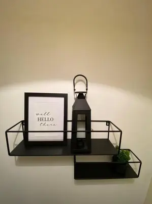 a black shelf with a candle and a picture at Lanfine View 1 at Loudoun Mains with Hot Tub in Newmilns