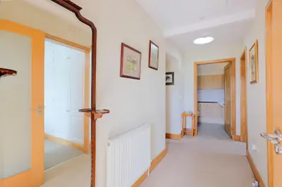 a hallway with a door leading into a room at Teapot Cottage in Newton Stewart
