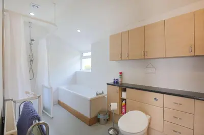a bathroom with a tub and a toilet and a sink at Teapot Cottage in Newton Stewart