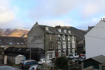 a group of buildings with cars parked in a parking lot at Bluestones in Keswick