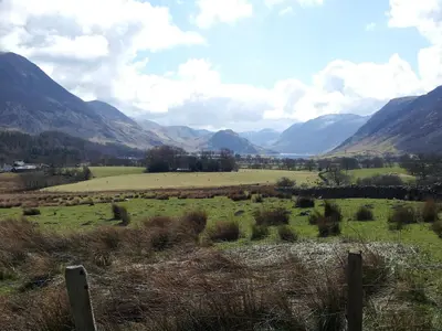 a green field with mountains in the background at Bluestones in Keswick