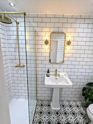 a bathroom with a sink and a mirror and a shower at The Cottage @ 59 in Colmonell