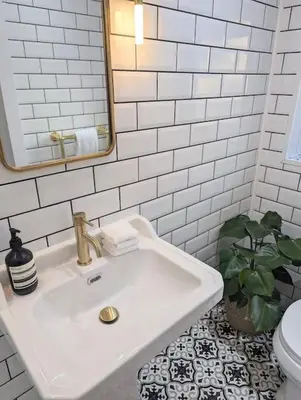 a white bathroom with a sink and a toilet at The Cottage @ 59 in Colmonell