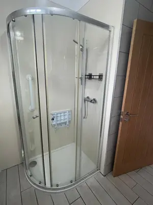 a shower with a glass door in a bathroom at Paxville in Gretna