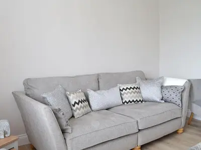 a gray couch with pillows in a living room at Paxville in Gretna