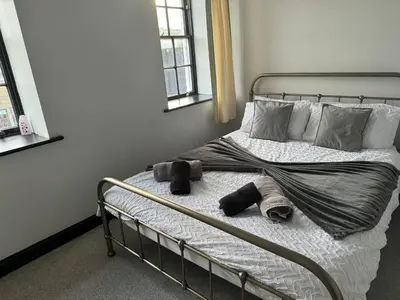 a bed with towels and pillows on it in a bedroom at The Lowther Penthouse - 2 Bedrooms - Sleeps 4 in Whitehaven