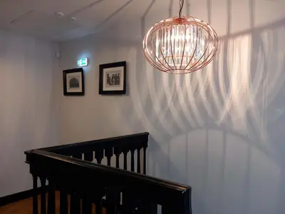 a hallway with a staircase and a chandelier at The Lowther Penthouse - 2 Bedrooms - Sleeps 4 in Whitehaven