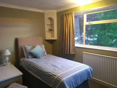 a small bedroom with a bed and a window at Number Fifty-Six Ramsey Villa in Ramsey