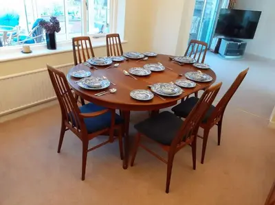 a wooden table with chairs and plates on it at Number Fifty-Six Ramsey Villa in Ramsey