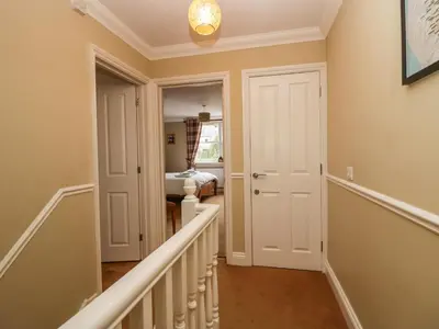 a hallway with a staircase leading to a bedroom at Castle Crag in Keswick