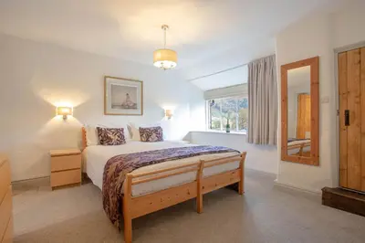 a bedroom with a large bed and a window at Goody Bridge Barn in Grasmere