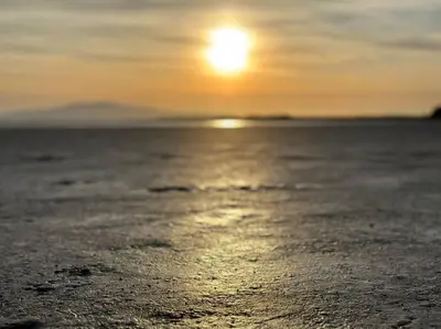 a sunset on a beach with the sun in the sky at Bonshaw Grange-Riverside Country Retreat, & HotTub in Lockerbie