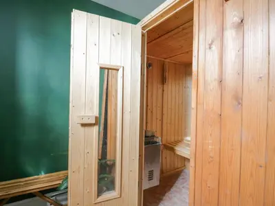 a room with wooden walls and a green wall at The Hollies in Carlisle
