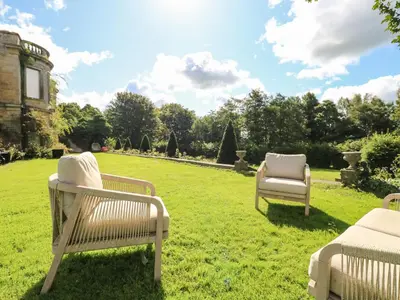 a group of chairs sitting on the grass in a yard at The Courtyard in Carlisle