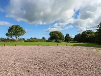 a large dirt field with trees in the background at The Courtyard in Carlisle