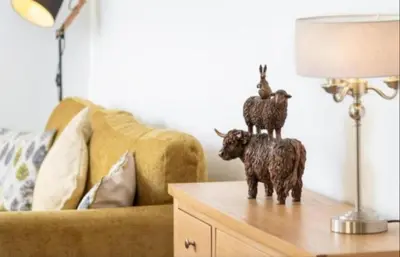 a statue of two goats on a table next to a couch at Church House Barn Lake District & Solway Coast with Solway Firth views in Silloth