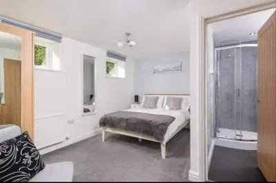 a white bedroom with a bed and a window at Church House Barn Lake District & Solway Coast with Solway Firth views in Silloth