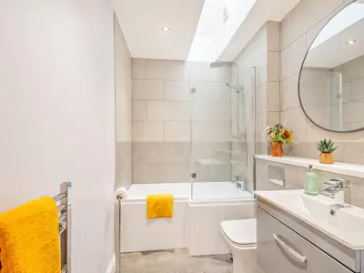 a bathroom with a sink and a tub and a toilet at The Byre - Uk45343 in Ayr