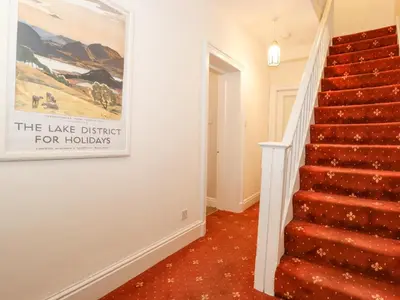 a staircase in a home with a painting on the wall at Riverbank in Ambleside