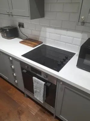a kitchen with a stove top oven in a kitchen at Kirkcudbright Holiday Apartments - Apartment D in Kirkcudbright