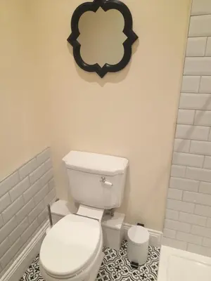 a bathroom with a white toilet and a black and white tile floor at Kirkcudbright Holiday Apartments - Apartment D in Kirkcudbright