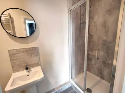 a bathroom with a shower and a sink and a mirror at Carvetii - ANNE House Room 1 - Dbl bed Ground floor en-suite in Carlisle