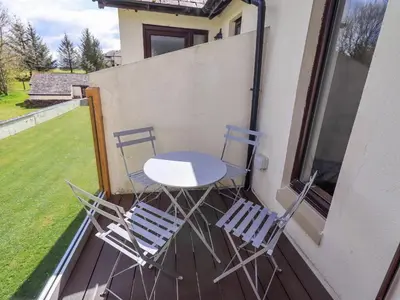 three chairs and a table on a balcony at Mallard Cottage Lake District, Leisure Spa Pool & Gym in Penruddock