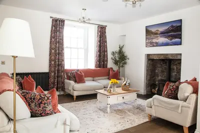 a living room with two couches and a fireplace at Stunning Scottish Hot Tub Getaway in Gatehouse of Fleet