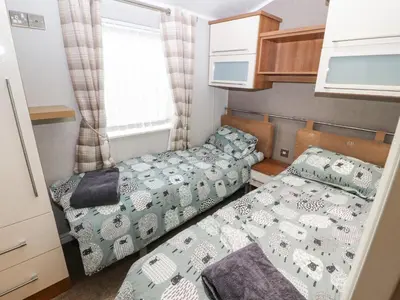 a small bedroom with two beds in it at No 7 Skiddaw View in Cockermouth