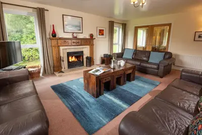 a living room with a couch and a fireplace at Spedding Fold Chapel Stile in Chapel Stile