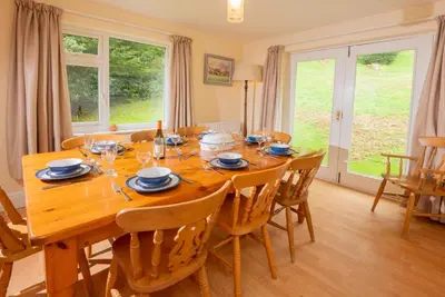 a dining room with a wooden table and chairs at Spedding Fold Chapel Stile in Chapel Stile