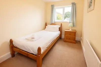 a small bedroom with a bed and a window at Spedding Fold Chapel Stile in Chapel Stile