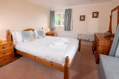 a bedroom with a large bed and a window at Spedding Fold Chapel Stile in Chapel Stile
