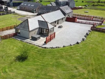 an aerial view of a building with a large yard at Middle Byre at Clauchan Holiday Cottages in Gatehouse of Fleet