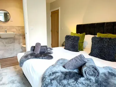 a bed with blankets and pillows on top of it at Carvetii - ANNE House Room 2 - Dbl bed First floor en-suite in Carlisle