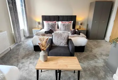 a bedroom with a bed and a couch and a table at Carvetii - ANNE House Room 3 - Triple bed first flr en-suite in Carlisle