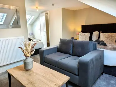 a living room with a couch and a bed at Carvetii - ANNE House Room 4 - Triple bed 2nd floor en-suite in Carlisle