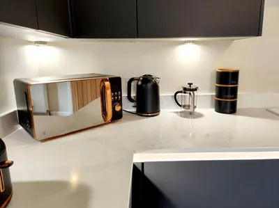 a kitchen counter with a toaster and a microwave on it at Carvetii - ANNE House Room 4 - Triple bed 2nd floor en-suite in Carlisle