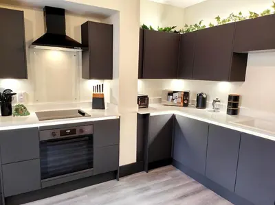 a kitchen with white counter tops and brown cabinets at Carvetii - ANNE House Room 4 - Triple bed 2nd floor en-suite in Carlisle