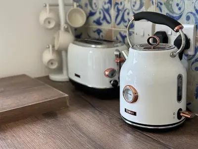 a tea kettle and toaster sitting on a counter at Oak View Lodge: Cosy, Countryside Retreat in Maybole