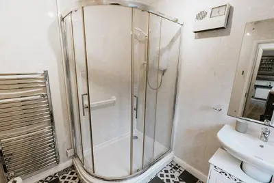 a bathroom with a shower and a sink at Winnie's Cottage - 3 Bed Accommodation in Cumbria in Mealsgate