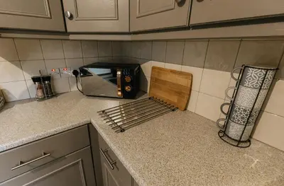 a kitchen counter with a toaster oven on a counter top at Winnie's Cottage - 3 Bed Accommodation in Cumbria in Mealsgate